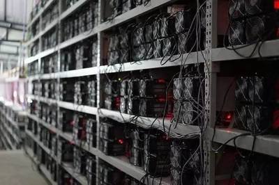 A sprawling cryptocurrency mining farm with racks of mining machines