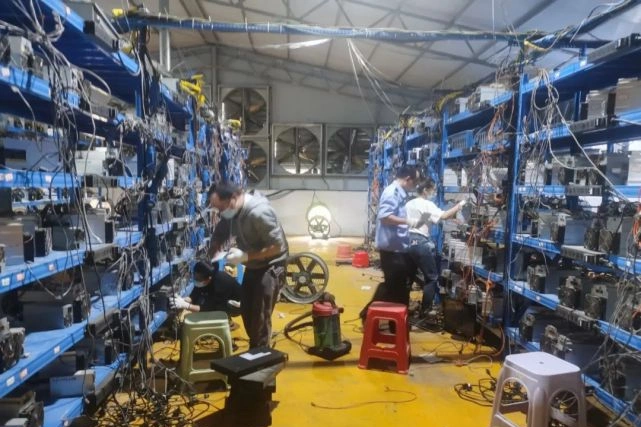 An aerial view of a modern mining farm utilizing wind energy, showcasing rows of efficient miners in harmony with nature