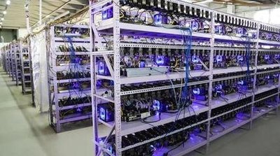 Large-scale mining farm with rows of ASIC miners illuminated by neon lighting