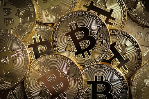 Bitcoin logo superimposed on a server farm representing the secure environment provided by hosting services.
